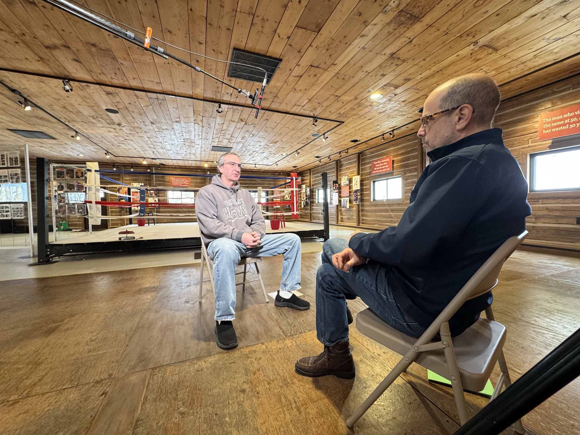 An interview under way beside the ring at a boxing gym